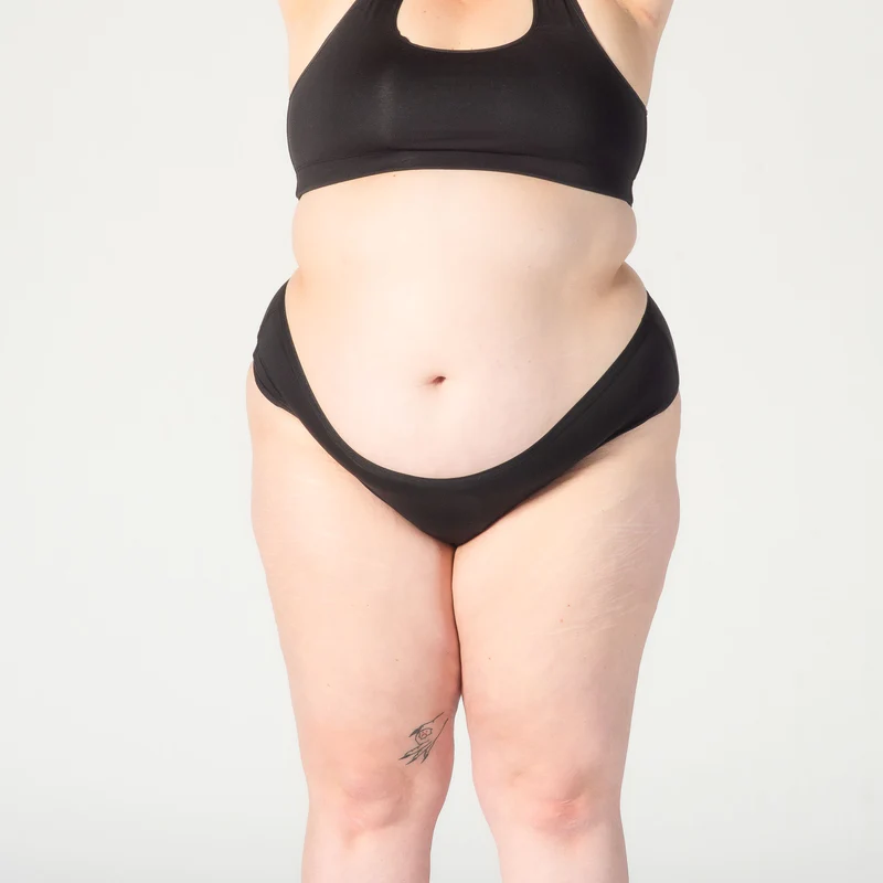 A fat white woman wearing black panties