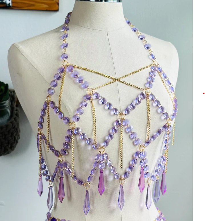 A lavender crystal bralette laid over a mannequin 