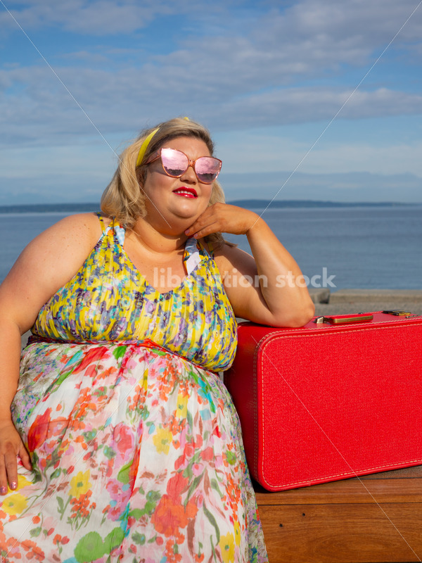 Body-Positive Stock Photo: Plus Size Woman Looks off Camera Leaning on a Red Suitcase - It's time you were seen ⟡ Body Liberation Photos
