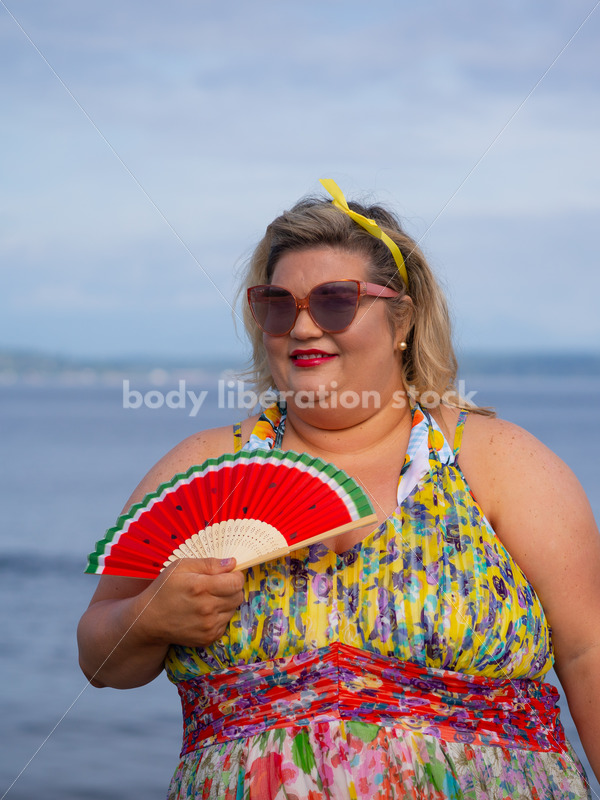 Body-Positive Stock Photo: Plus Size Woman Poses in Front of the Ocean with a Watermelon Fan - It's time you were seen ⟡ Body Liberation Photos