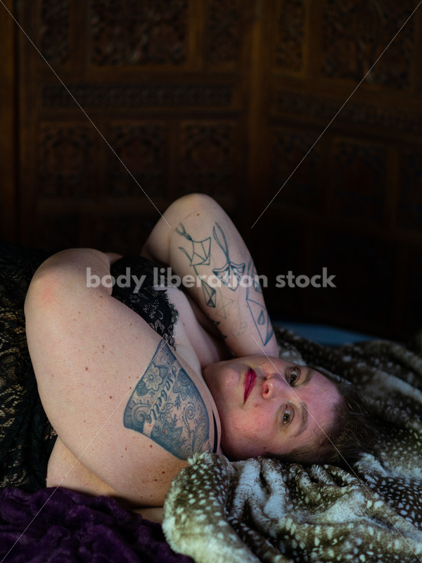 Body-Positive Stock Photo: Plus Size Woman Relaxing on Soft Blankets with a Daring Expression - Body liberation for all! Body positive stock and client photography + more | Seattle