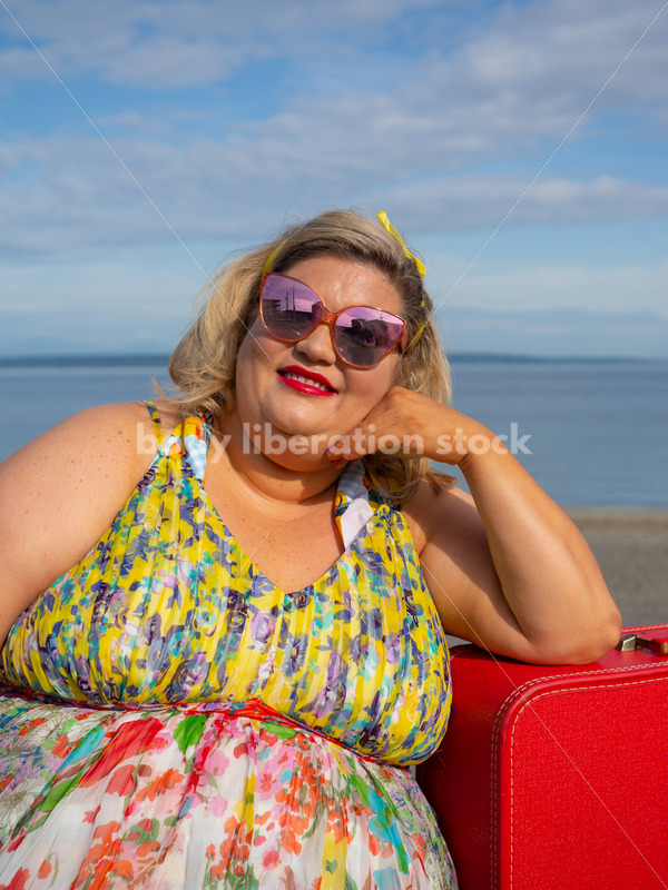 Body-Positive Stock Photo: Plus Size Woman Smiles Leaning on a Red Suitcase - It's time you were seen ⟡ Body Liberation Photos