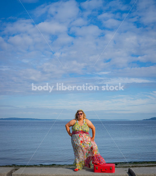 Body-Positive Stock Photo: Plus Size Woman Stands by the Ocean with One Foot on a Red Suitcase - It's time you were seen ⟡ Body Liberation Photos