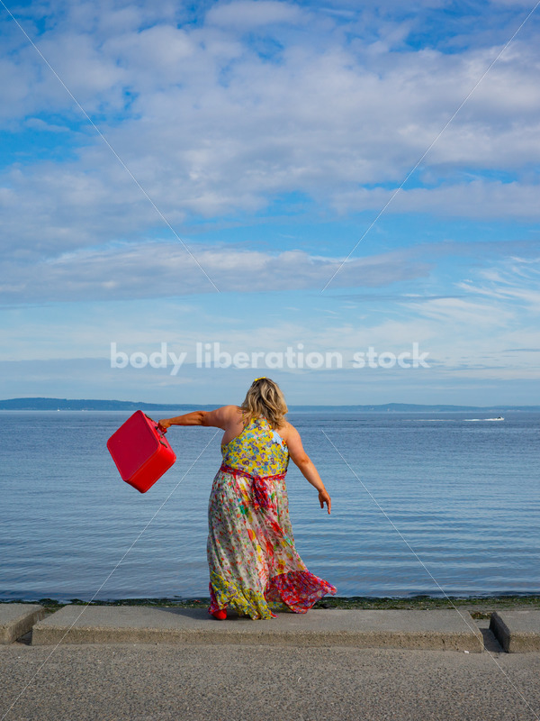 Body-Positive Stock Photo: Plus Size Woman Swinging a Suitcase on the Beach - It's time you were seen ⟡ Body Liberation Photos