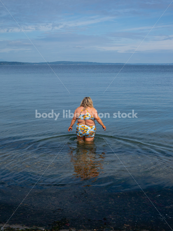 Body-Positive Stock Photo: Plus Size Woman in a Blue Swimsuit Wades Into the Ocean - It's time you were seen ⟡ Body Liberation Photos