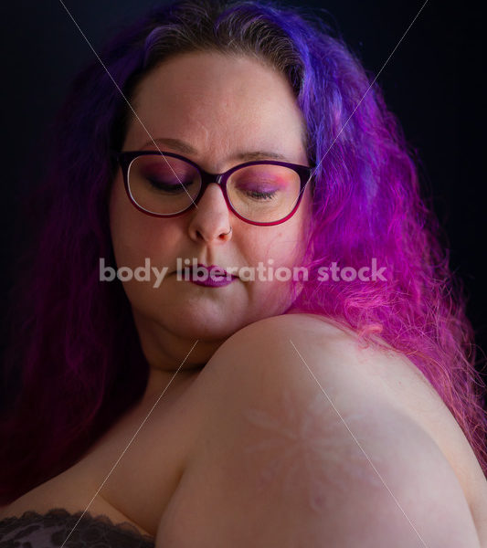 Fat-Positive Stock Photo: Plus-Size Woman with Purple Hair and Dark Lipstick with Downward Gaze - Body Liberation Photos