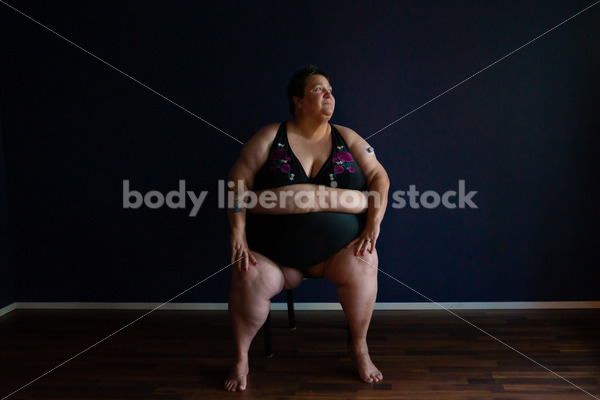 Plus Size Stock Photo: Woman in Dark Room - Body Liberation Photos