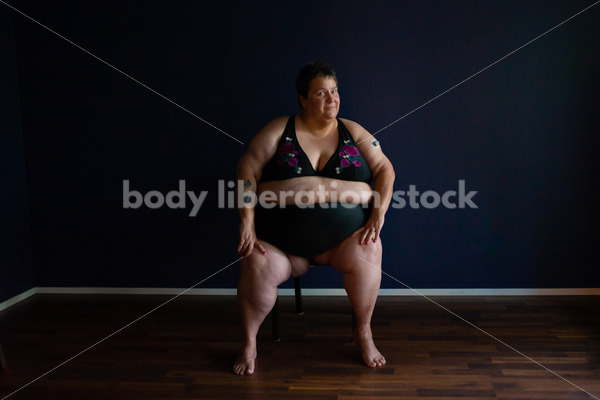 Plus Size Stock Photo: Woman in Dark Room - Body Liberation Photos