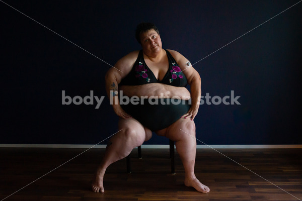 Plus Size Stock Photo: Woman in Dark Room - Body Liberation Photos